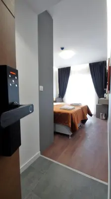 a bedroom with a bed and a tv in a room at Lolo Luxury rooms & suites in Budva