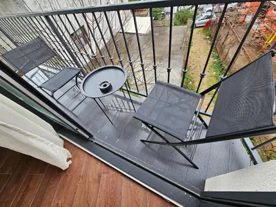 a view of a balcony with chairs and a table at Lolo Luxury rooms & suites in Budva