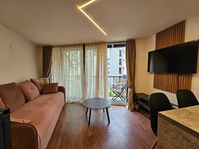 a living room with a couch and a table at Lolo Luxury rooms & suites in Budva