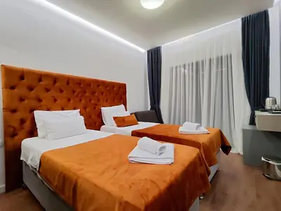 a hotel room with two beds with towels on them at Lolo Luxury rooms & suites in Budva
