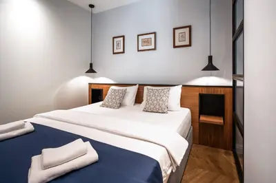 a bedroom with a large white bed with two pillows at Nest Ozana in Kotor
