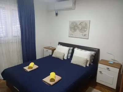 a bedroom with a bed with two towels on it at Stan u maslinama in Podgorica