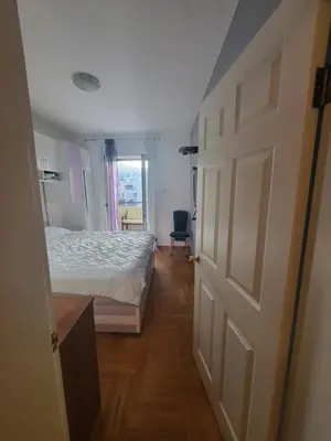 a bedroom with a bed and an open door at Family apartment Maxema in Budva