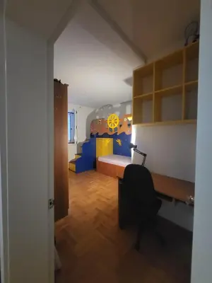 a room with a bedroom with a bed and a desk at Family apartment Maxema in Budva