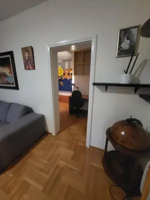 a living room with a couch and a table at Family apartment Maxema in Budva