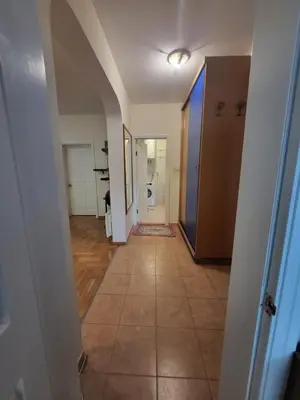 a hallway with a tile floor and an open door at Family apartment Maxema in Budva