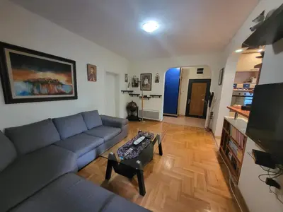 a living room with a couch and a table at Family apartment Maxema in Budva