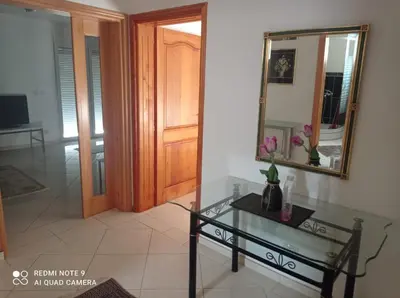 a room with a glass table and a mirror at Montenegro Smile in Dobra Voda
