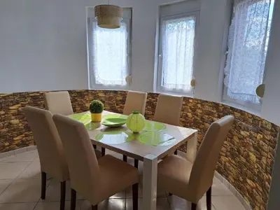 a dining room with a wooden table and chairs at Montenegro Smile in Dobra Voda