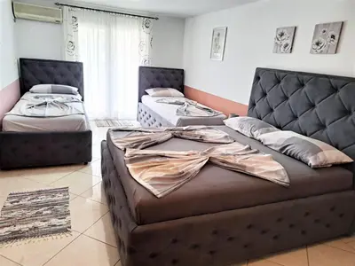 a living room with two beds and a couch at Montenegro Smile in Dobra Voda