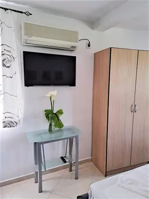 a room with a table with a flower on it at Montenegro Smile in Dobra Voda