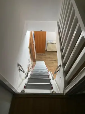 a staircase leading up to a room with a wooden door at Mountain house Ivanova Korita in Cetinje