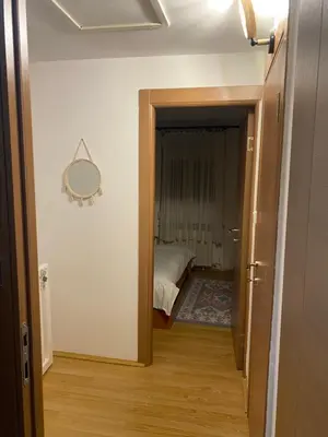 a hallway with a room with a bed and a mirror at Mountain house Ivanova Korita in Cetinje