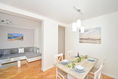 a living room with a table and a couch at Unico apartman in Kotor