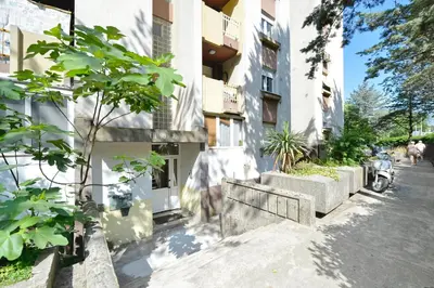 a building with a motorcycle parked in front of it at Unico apartman in Kotor