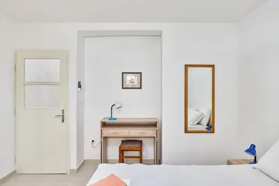 a bedroom with a bed and a mirror at Apartment Pavle in Kotor