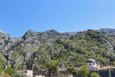 a church on a mountain with a mountain at Apartment Pavle in Kotor