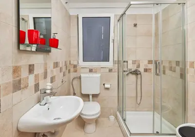 a bathroom with a toilet and a sink and a shower at Apartment Pavle in Kotor