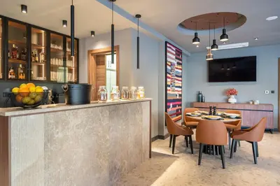 a restaurant with a bar with a table and chairs at C Group apartments in Kotor