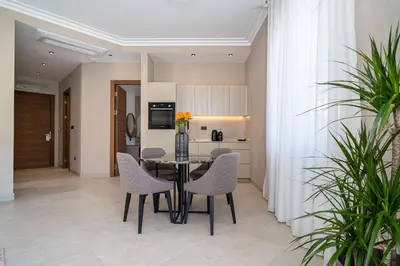 a dining room with a table and chairs at C Group apartments in Kotor