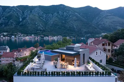 an aerial view of a house with mountains in the background at C Group apartments in Kotor
