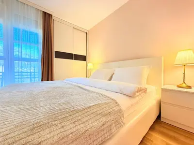 a bedroom with a white bed and a window at Apartment Hana in Bar