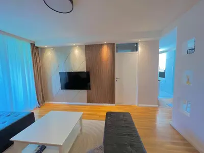 a living room with a couch and a tv at Apartment Hana in Bar