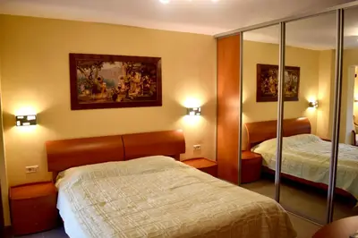 a hotel room with two beds and a mirror at Family Villa in Petrovac na Moru
