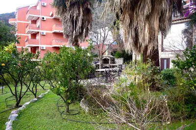 a view of a building and a garden with trees at Family Villa in Petrovac na Moru