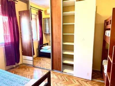a mirror in a room with a bed and a chair at KotorHostelito in Kotor