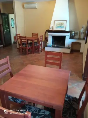 a dining room with tables and chairs and a fireplace at KotorHostelito in Kotor