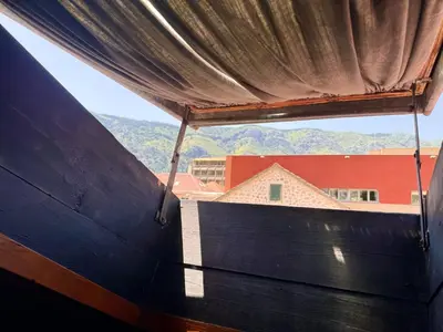 a view from a window of a building with mountains in the background at KotorHostelito in Kotor