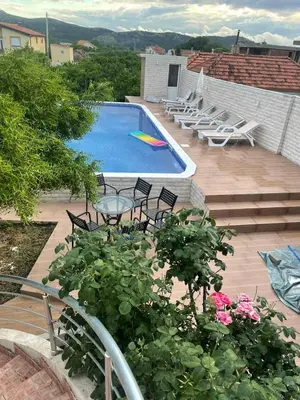 a swimming pool with chairs and a frisbee at Villa Nilić in Bar