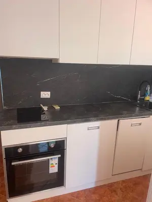 a kitchen with a black counter top and a stove at Villa Nilić in Bar