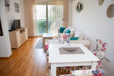 a living room with a white table and chairs at Apartments LORA Cetinjska18 in Budva