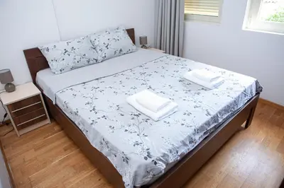 a bed with two pillows on it in a bedroom at Apartments LORA Cetinjska18 in Budva