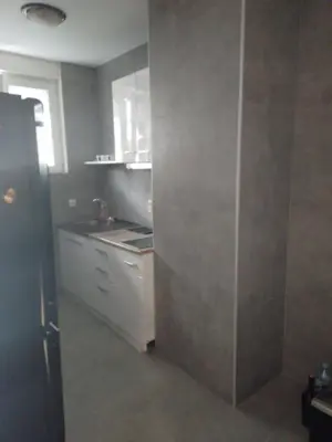 a small kitchen with a sink and a counter at Dominik in Bar