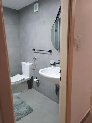 a bathroom with a sink and a toilet and a mirror at Dominik in Bar