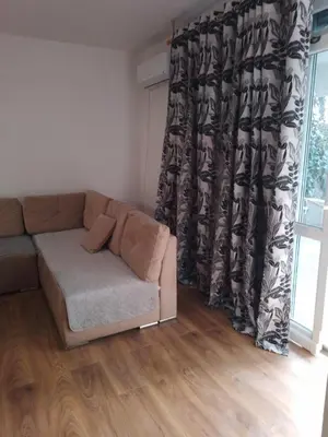a living room with a couch and a window at Dominik in Bar