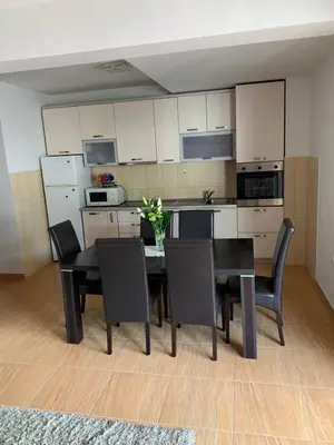 a kitchen with a dining room table and chairs at Apartment IDA in Budva