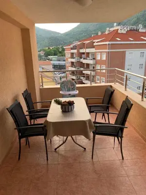 a table and chairs on a balcony with a view at Apartment IDA in Budva