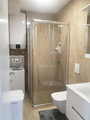 a bathroom with a shower and a toilet at APARTMENT DZANA in Dobra Voda