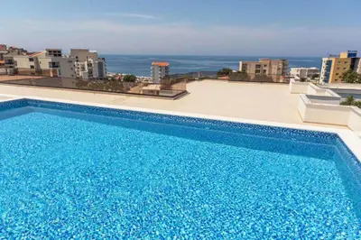 a large blue swimming pool on top of a building at APARTMENT DZANA in Dobra Voda