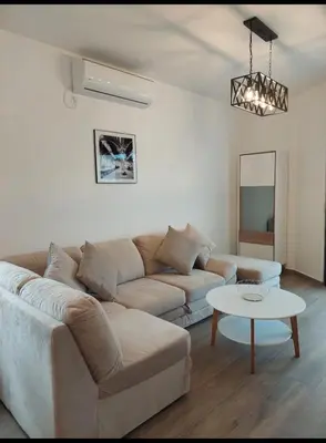 a living room with a couch and a table at APARTMENT DZANA in Dobra Voda