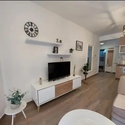a living room with a flat screen tv on a wall at APARTMENT DZANA in Dobra Voda