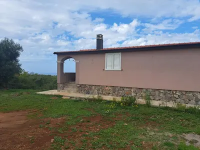 a house with a stone wall and a window at Holiday Home Apartment Ceranic Kotor Tivat in Kotor