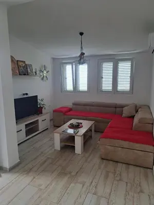 a living room with a couch and a table at Holiday Home Apartment Ceranic Kotor Tivat in Kotor