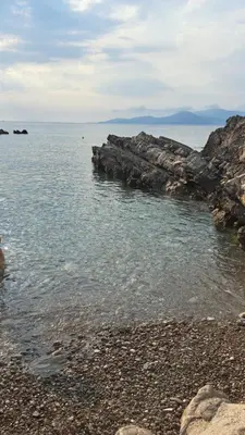 a group of rocks in the water on a beach at Holiday Home Apartment Ceranic Kotor Tivat in Kotor
