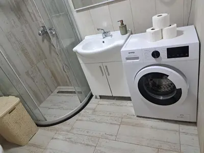a bathroom with a washing machine and a sink at Holiday Home Apartment Ceranic Kotor Tivat in Kotor