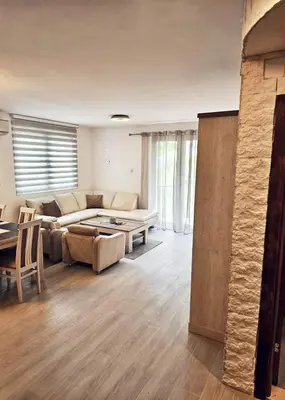 a living room with a couch and a table at A&A Apartment in Blue Horizon Przno with pool in Budva